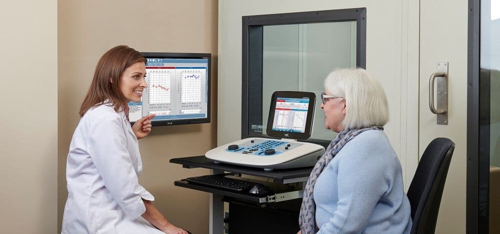 An audiologist reviewing audiometry test results with a patient