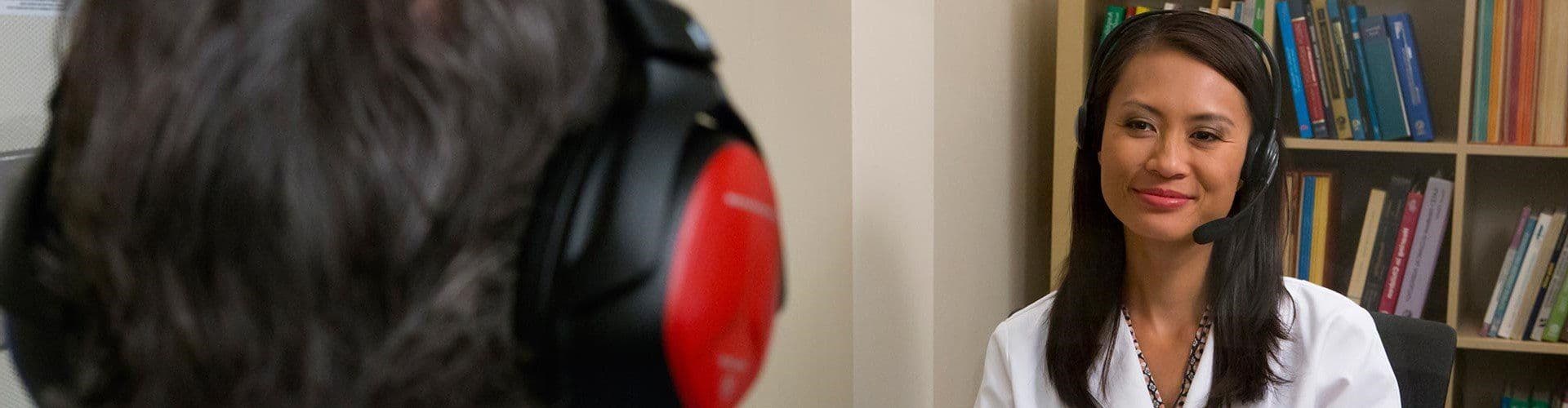 An audiologist testing a patient